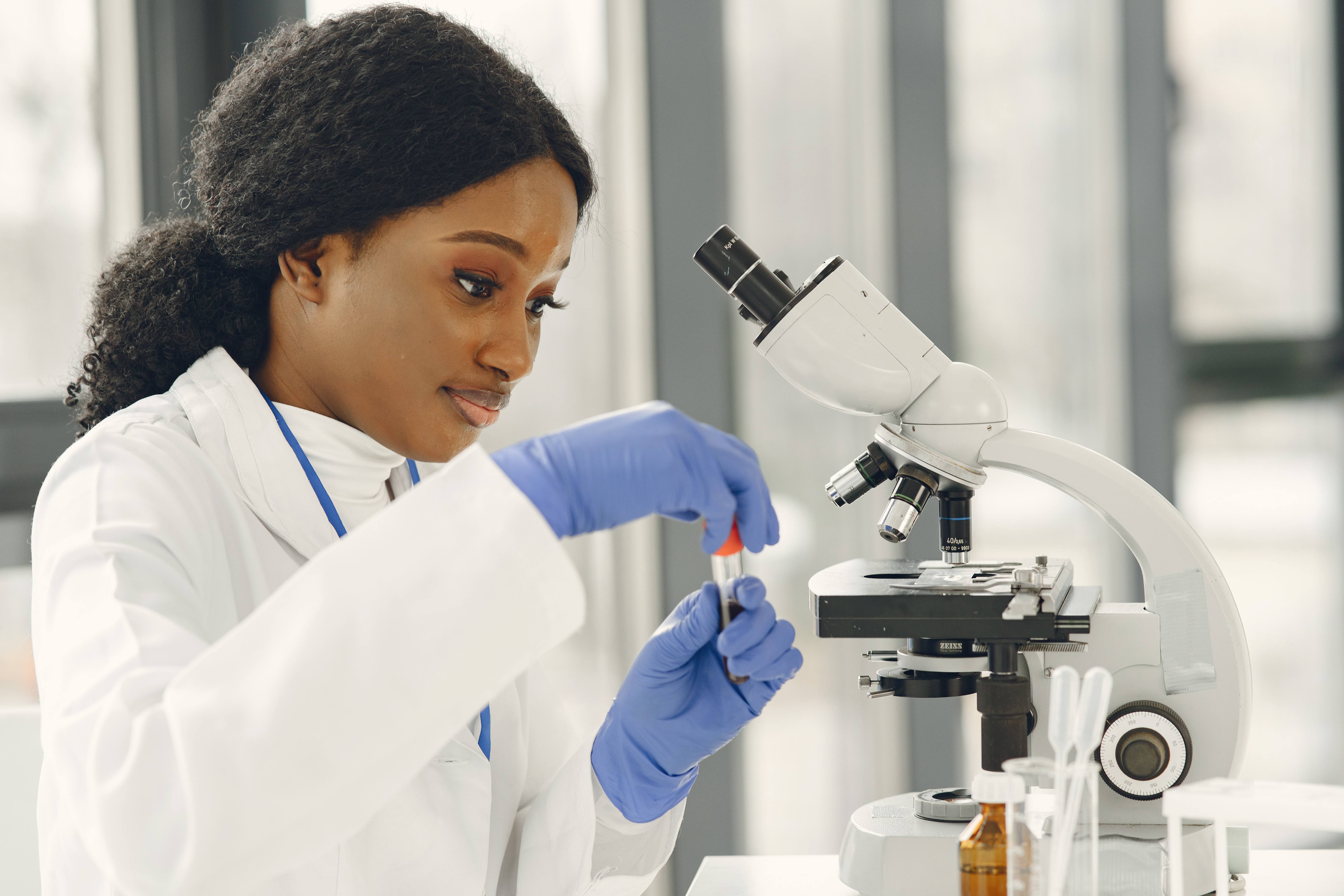 medical-doctor-girl-working-with-microscope-young-female-scientist-doing-vaccine-research-1.jpg
